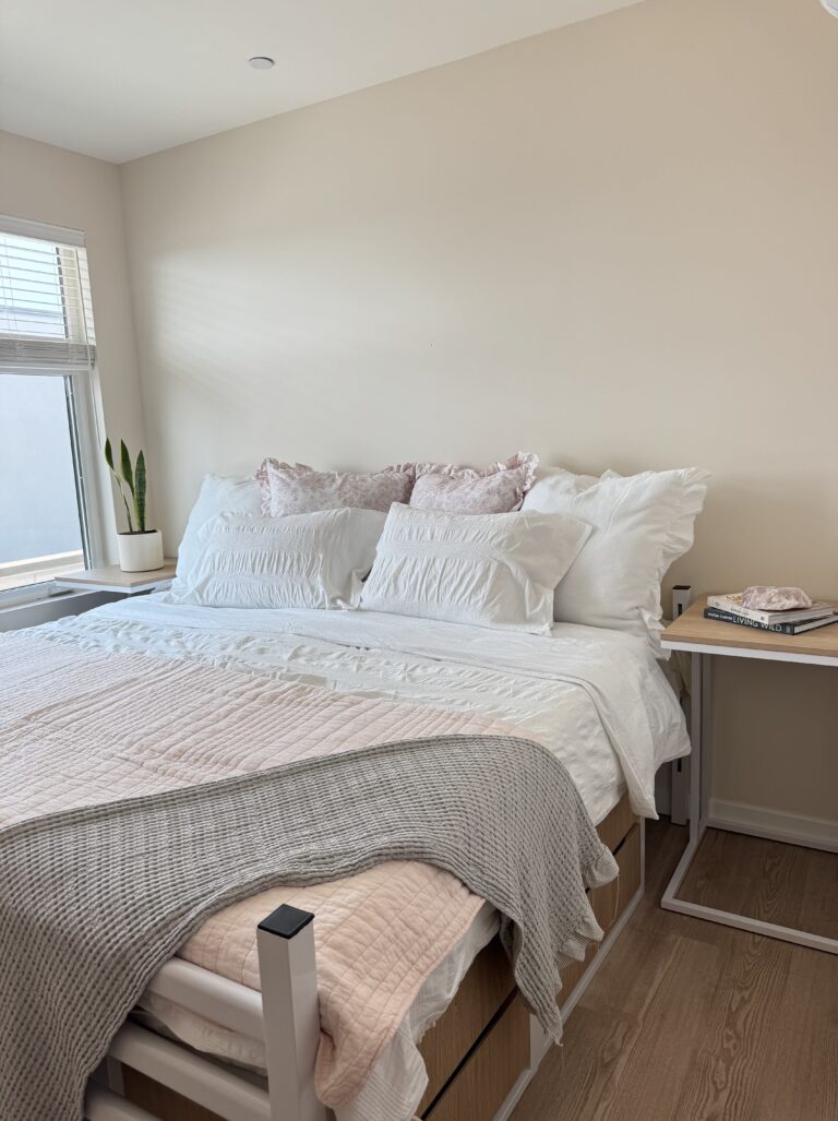 a bed with pillows and a table